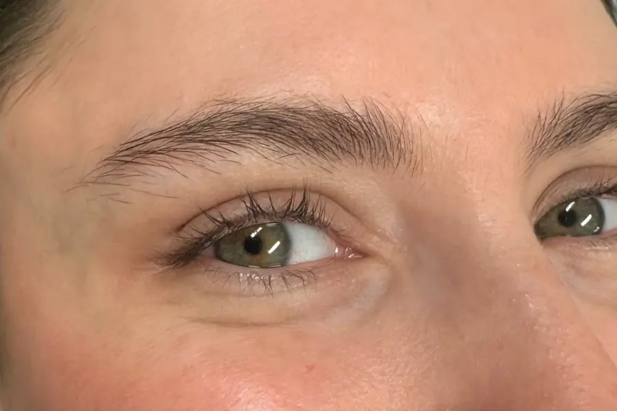 A client’s lashes and brows before a Korean lash lift