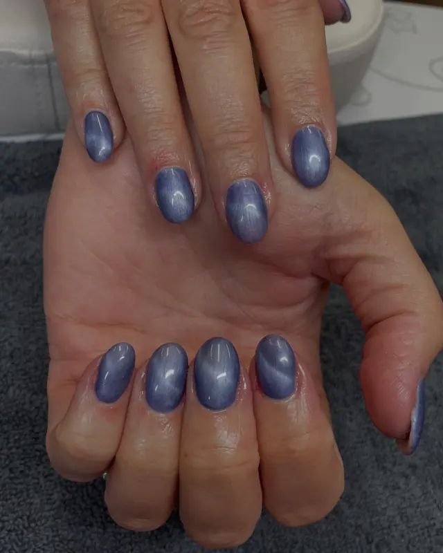 Blue cat eye gel nails with a marble look