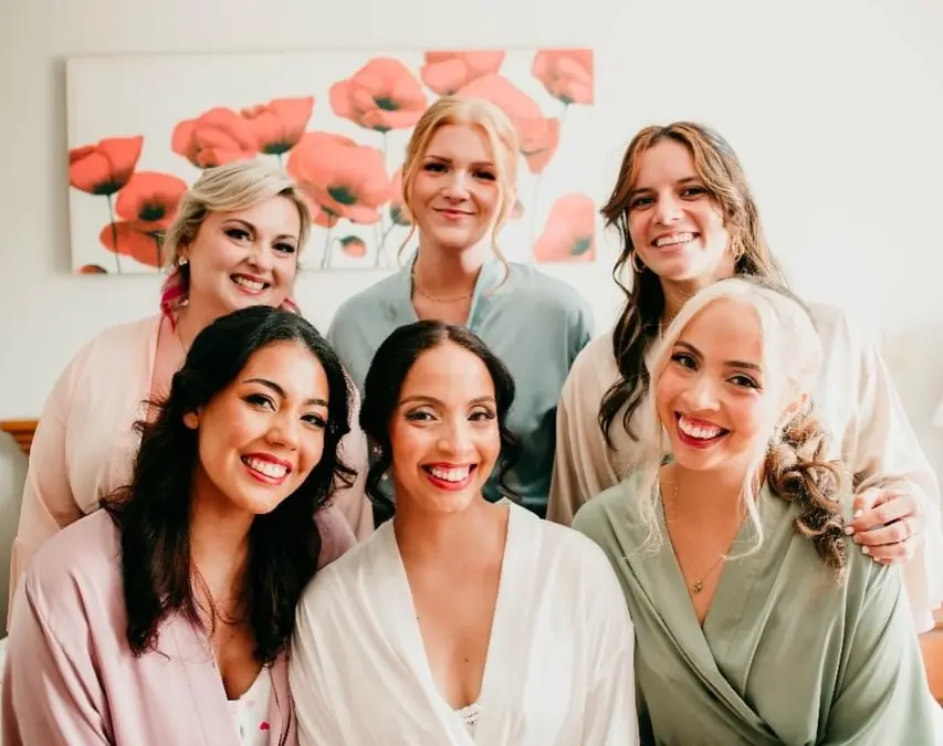 The bride and her bridal party in robes with their makeup done